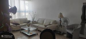 a living room with a couch and a table at Apartments Haagna in Ashdod