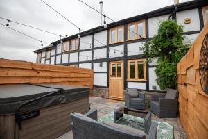 a backyard with a wooden fence and a house at Bramble Cottage - Cosy 2 Bed With Deluxe HOT TUB & Log Burner in Hereford