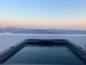 a swimming pool on the roof of a building at Imerti Suites in Oia