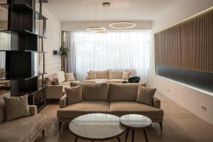 a living room with two couches and a table at Complex Hotelier Steaua de Mare - Hotel Delfinul in Eforie Nord