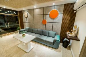 a living room with a couch and a table at Jeyam Residency in Puducherry