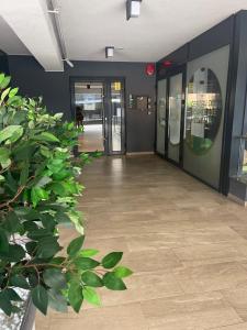 an empty hallway of an office with doors and plants at Apart Mihai Viteazu Residence in Braşov