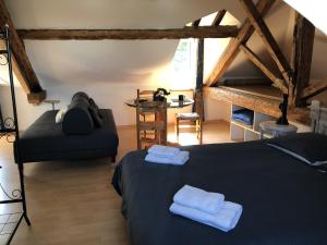 a bedroom with a bed and a table in a room at Demeure du NID de la Création in Vertou