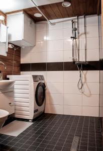 uma cozinha com uma máquina de lavar roupa na casa de banho em Talo saunalla ja sähköauton oma Type2 latauspiste em Vantaa