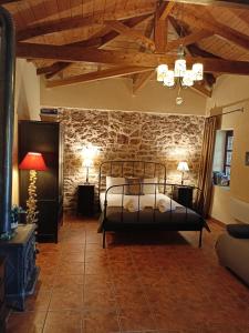 sypialnia z łóżkiem i kamienną ścianą w obiekcie Theopetra w mieście Theópetra