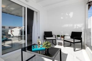 a living room with a glass table and chairs at Casa Fariones in Puerto del Carmen