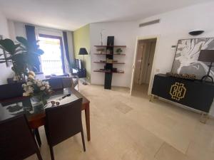 a living room with a table and a couch at Portico Sevilla in Seville