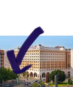 a purple object in front of a large building at Portico Sevilla in Seville