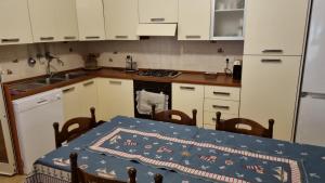 a kitchen with a table with a blue table cloth on it at Soluzionestate in Ispica