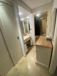 a bathroom with a sink and a mirror at Portico Sevilla in Seville