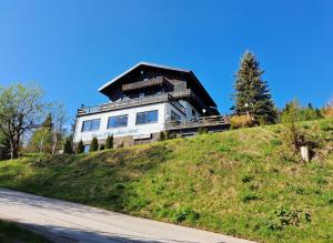 a house on top of a hill with a road at Blue Mountain Hotel in Afritz