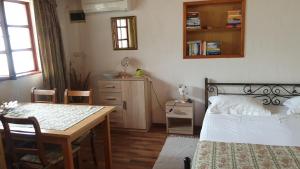 a bedroom with a bed and a table and a dining room at Apartments Karmen Funtana in Funtana