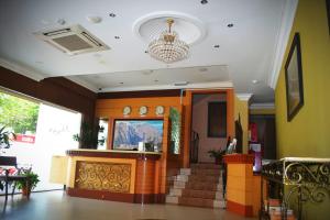 a lobby with a staircase and a chandelier at D'Borneo Hotel in Kota Kinabalu