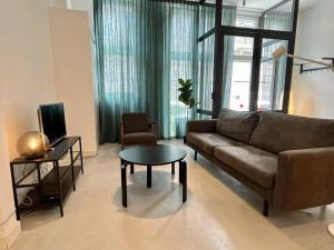 a living room with a couch and a table at Trendy 2 Bedroom Serviced Apartment in Rotterdam