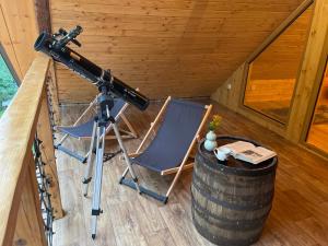 a camera and a chair in a room with a barrel at Wioska Kowala in Tyrawa Wołoska