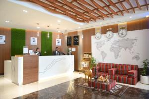 a lobby with a reception desk and a world map on the wall at Smana Hotel Al Raffa in Dubai
