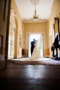 a bride and groom standing in the doorway of a room at Park House Hotel in Shifnal