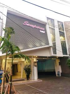 a store front with a sign on the side of it at Hotel Sampurna Cirebon in Cirebon