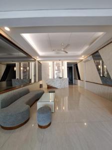 a living room with a couch and a table at Hotel Sampurna Cirebon in Cirebon