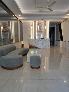 a lobby with two chairs and a table in a building at Hotel Sampurna Cirebon in Cirebon