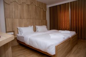 Un pat sau paturi într-o cameră la Stay Inn Hotel and Apartment Pokhara