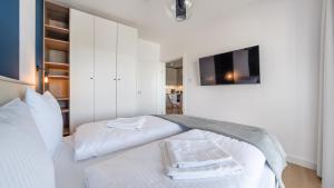 Posteľ alebo postele v izbe v ubytovaní Apartamenty Sun & Snow Polanki Aqua z basenem