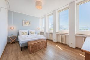 a bedroom with two beds in a room with windows at Himmelsstürmer Apartments by Stay Awesome in Kassel