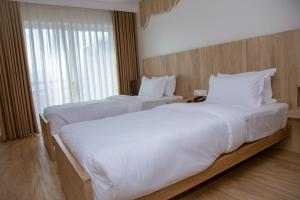 Un pat sau paturi într-o cameră la Stay Inn Hotel and Apartment Pokhara