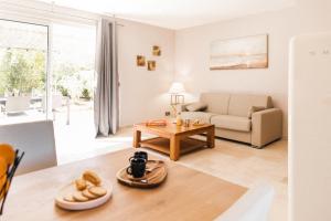 a living room with a couch and a table at Les Maisons Du Sud in Saint-Tropez