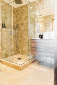 a bathroom with a shower and a sink at Les Maisons Du Sud in Saint-Tropez