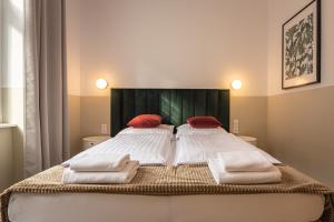 a bedroom with a bed with towels on it at Villa Wilda in Poznań