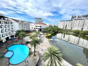 a large swimming pool in a city with buildings at Flamingo Hotel By The Lake, Kuala Lumpur in Kuala Lumpur