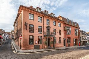 a large red brick building on a street at The George In Rye in Rye