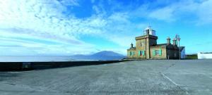 a lighthouse sitting on the side of a road at Fabulous Belmullet Townhouse in Belmullet