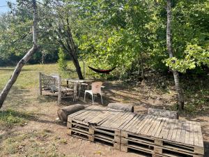 a hammock and a table and chairs in a park at Sveri Adventure Camp in Chiatʼura