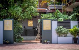 a entrance to a building with signs and plants at Grange in Siem Reap