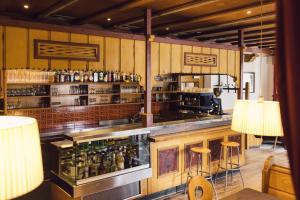 a bar with a counter with alcohol bottles at Parkhotel Schachen in San Giovanni in Val Aurina