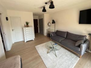 a living room with a couch and a table at Cozy studio apartment in Cannes - AC-Self check-in in Cannes