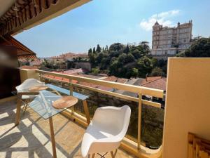 a balcony with chairs and a view of a city at Cozy studio apartment in Cannes - AC-Self check-in in Cannes