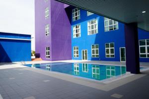 a building with a swimming pool in front of it at Zecon Hotel HPKK in Kuala Lumpur