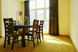 a dining room with a table and chairs and a window at Zecon Hotel in Kuala Lumpur