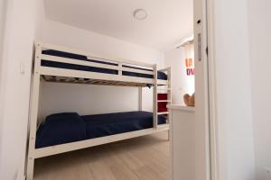 a bedroom with two bunk beds with blue sheets at Villa Cristina - Relax - Piscina e Vista Mare in Castellammare del Golfo +38 photos