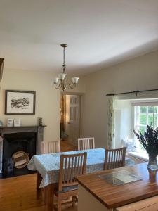 a dining room with a table and a fireplace at Plas yn Yale with mountain views from all windows in Wrexham