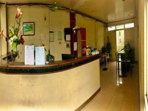 a lobby with a counter with flowers on it at WJV INN Marigondon in Agus