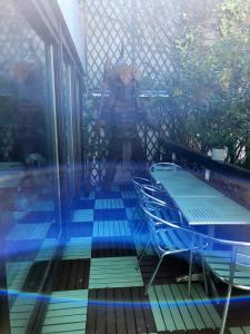 a patio with chairs and a table on a deck at Penthouse champs elysées above 5 stars hotel berri champs elysées in Paris