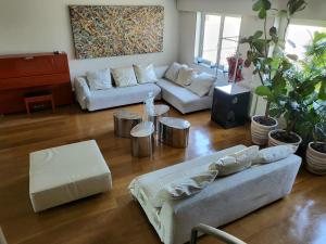 a living room with two couches and a piano at Penthouse champs elysées above 5 stars hotel berri champs elysées in Paris +17 photos