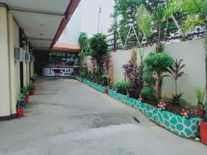 a courtyard of a building with plants on the side at WJV INN Bankal in Bankal