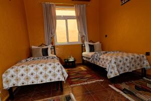 Postel nebo postele na pokoji v ubytování Riad Parfums de OUARZAZATE