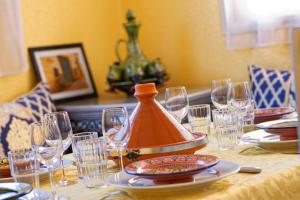 a table with glasses and a pot on top of it at Riad Parfums de OUARZAZATE in Ouarzazate