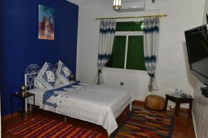 Postel nebo postele na pokoji v ubytování Riad Parfums de OUARZAZATE